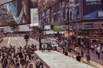 An urban street scene bustling with people, accompanied by a label describing the city and cultural highlights.