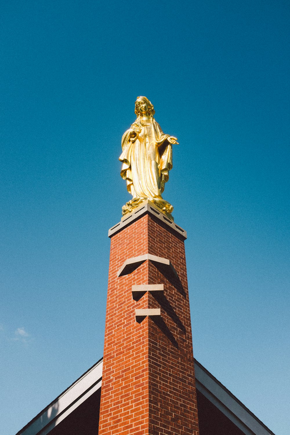 low angle photo of statue on tower