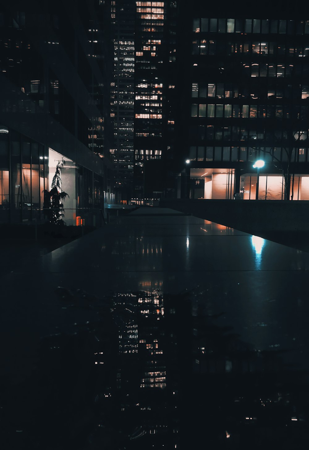 reflection of a high-rise building on body of water