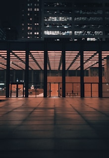 Evening shot of a completed office building glowing warmly against the dusk sky.