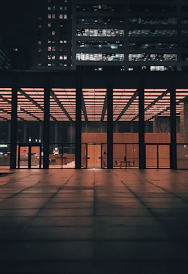 Wide shot of a contemporary office building illuminated at night.