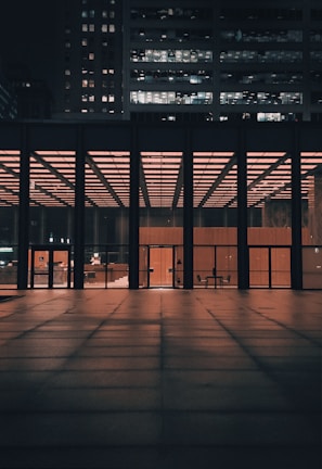 Night shot of a completed commercial building illuminated by warm lights.