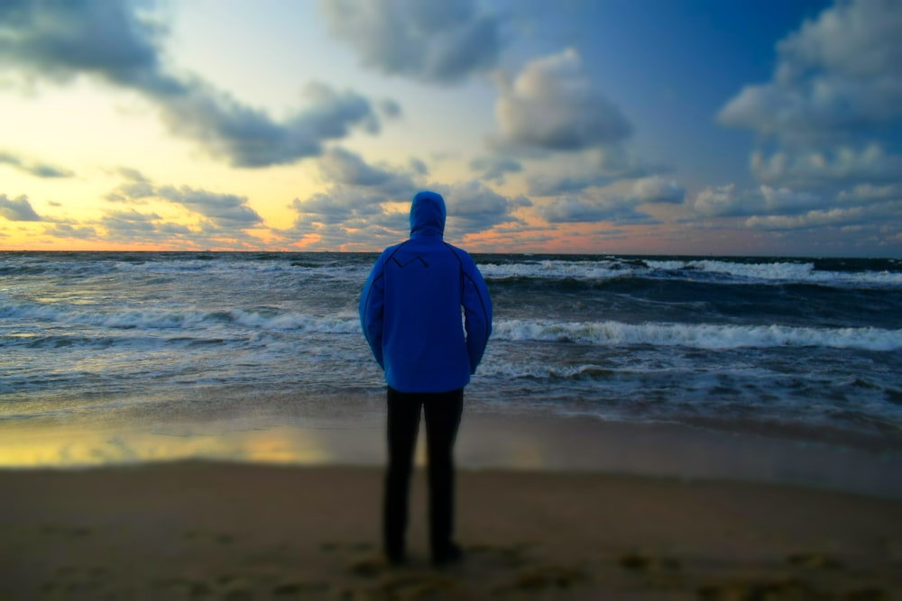 man standing in front of seashore