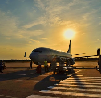 white airplane parked during daytime