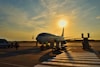 white airplane parked during daytime