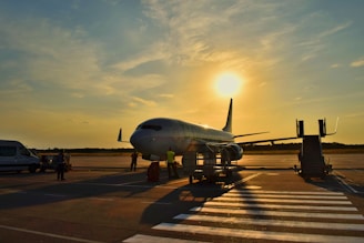 white airplane parked during daytime