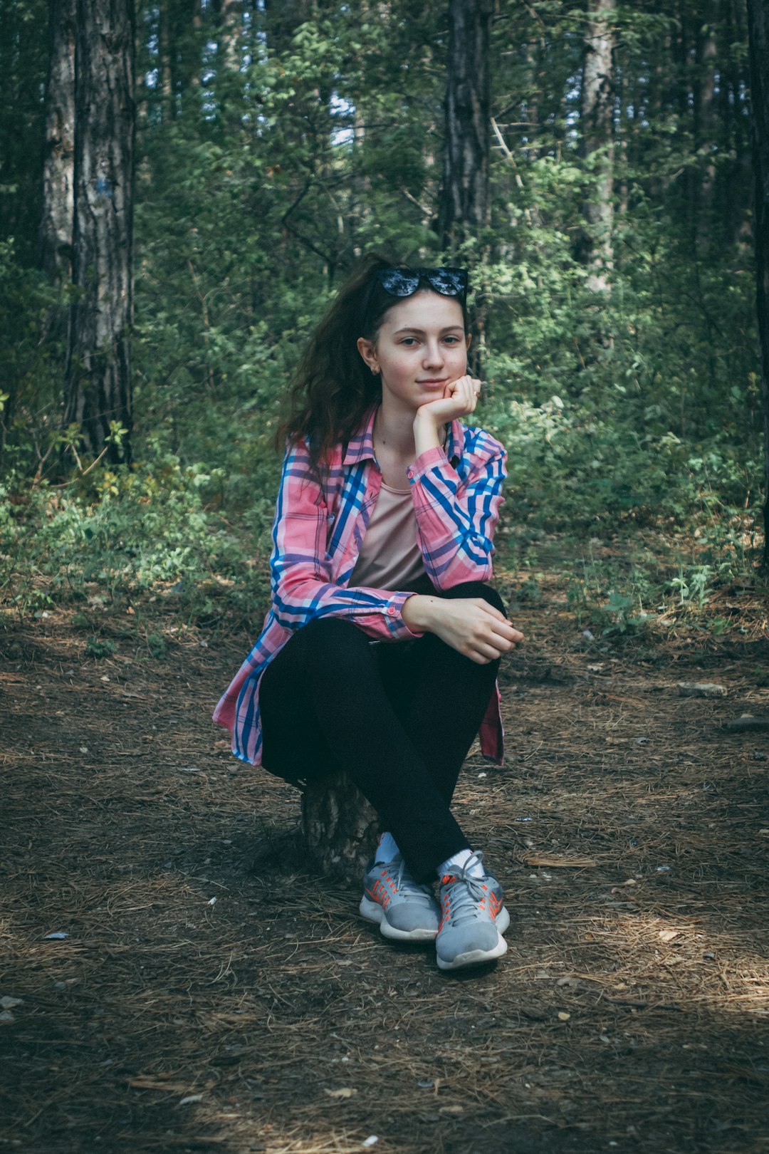 woman sitting on forest and smiling