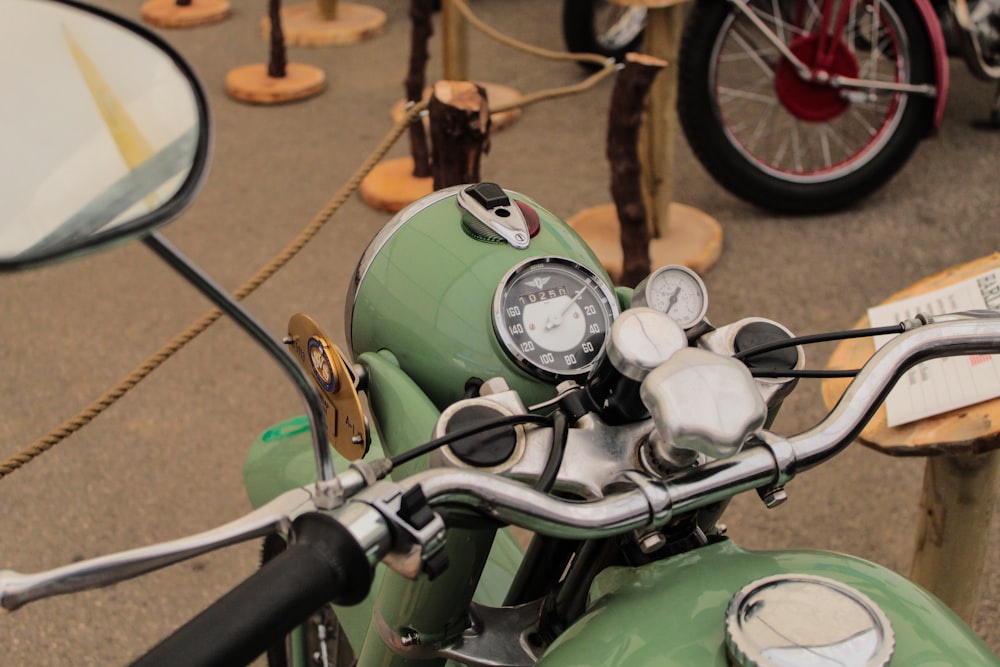 green motorbike in a lot during daytime close-up photography