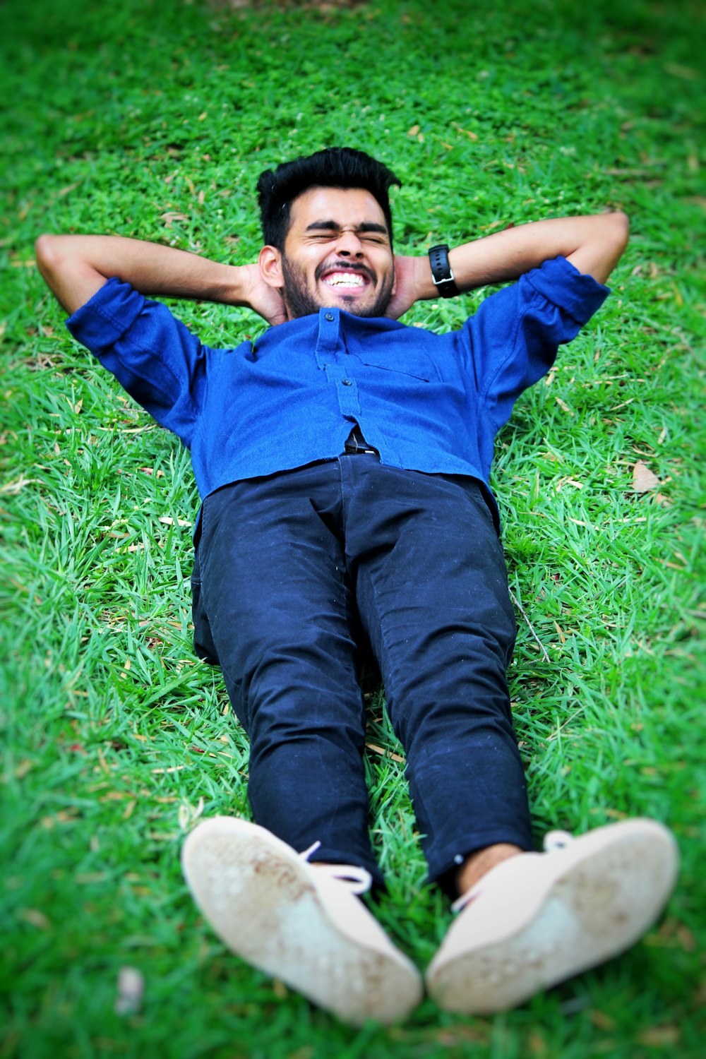 man lying on grass field