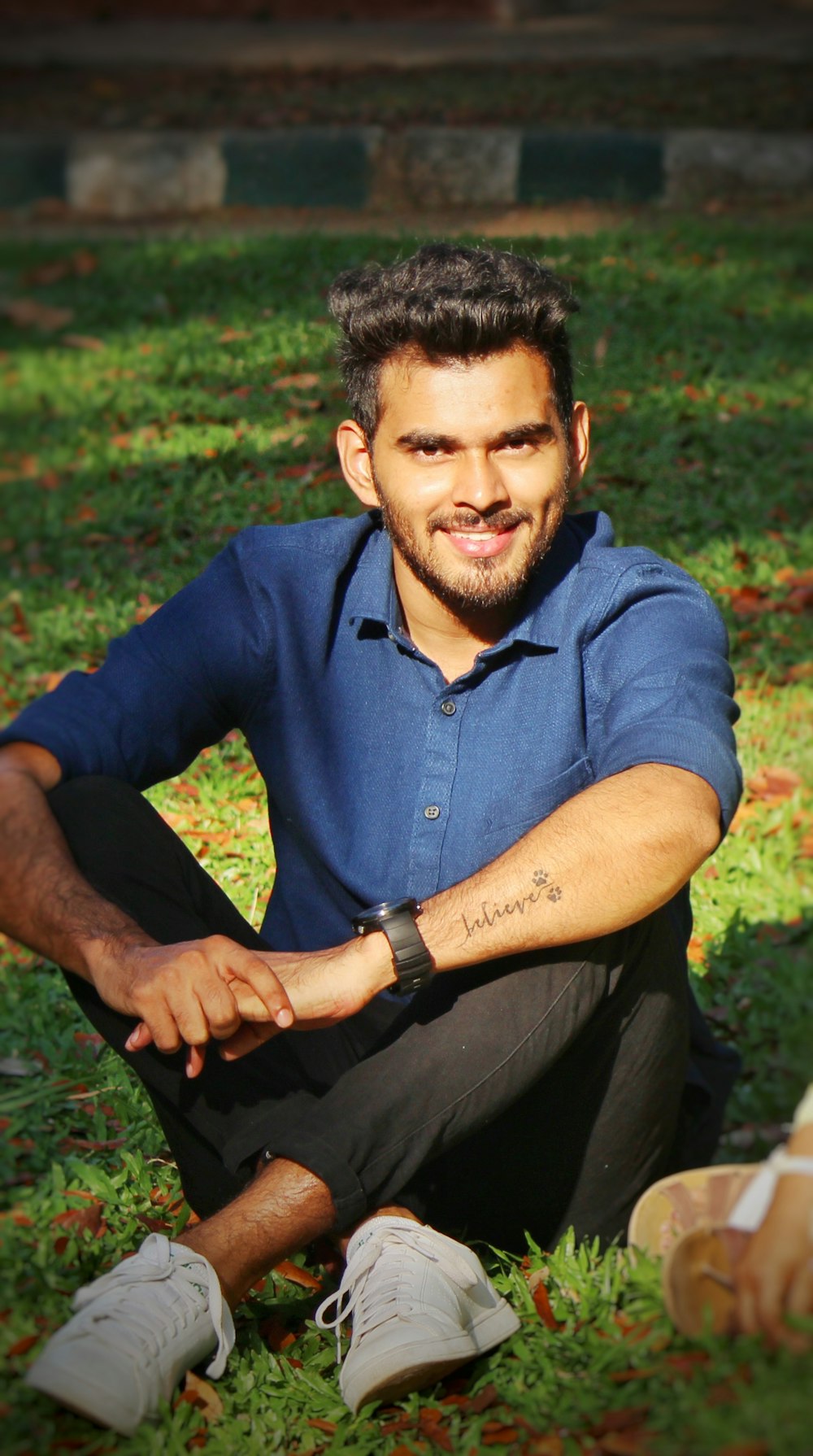 man sitting on grass ground