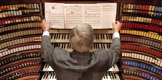person holding a piano note paper close-up photography