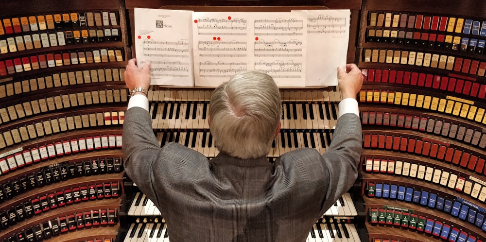 person holding a piano note paper close-up photography