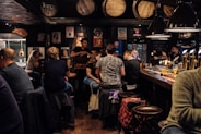 people sitting on bar chairs while drinking and talking