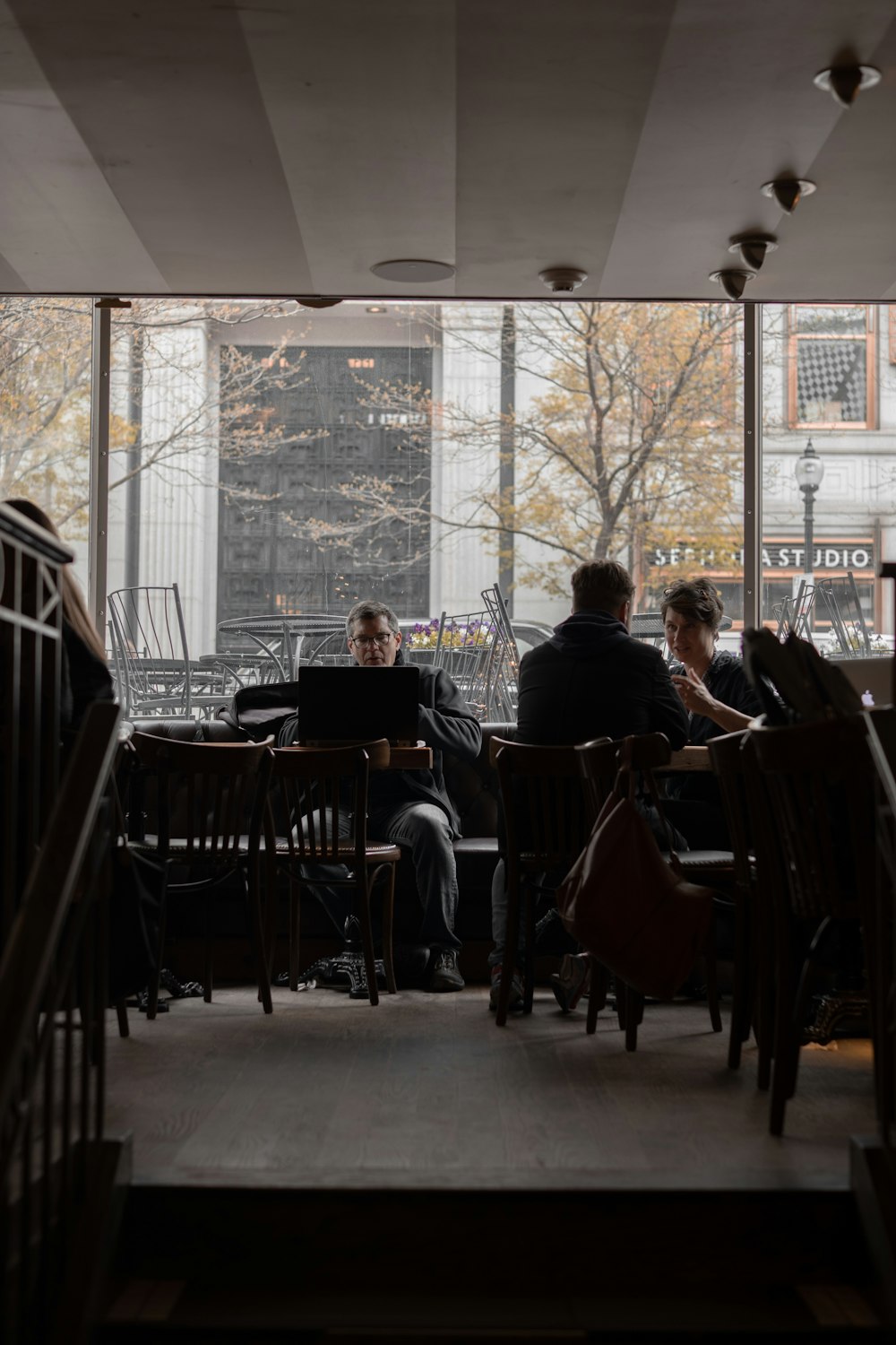 man sitting near the window photography