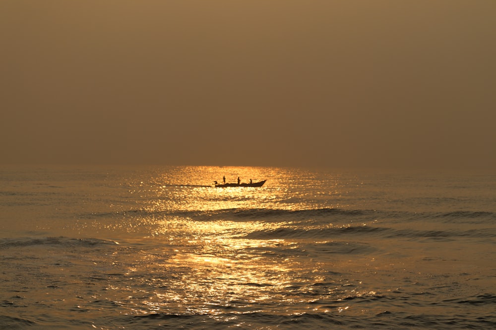 a couple of boats floating on top of a body of water