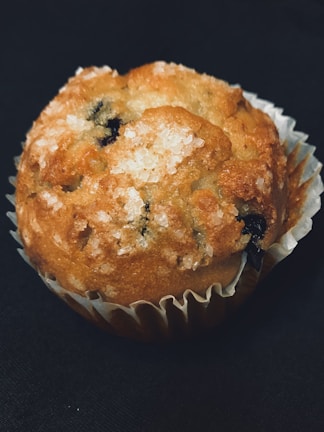 Close-up of a moist gluten-free muffin with a golden crust.
