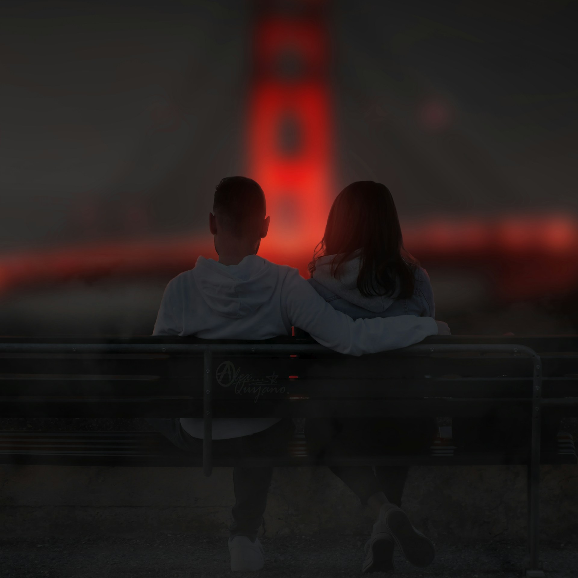 man and woman sitting on bench