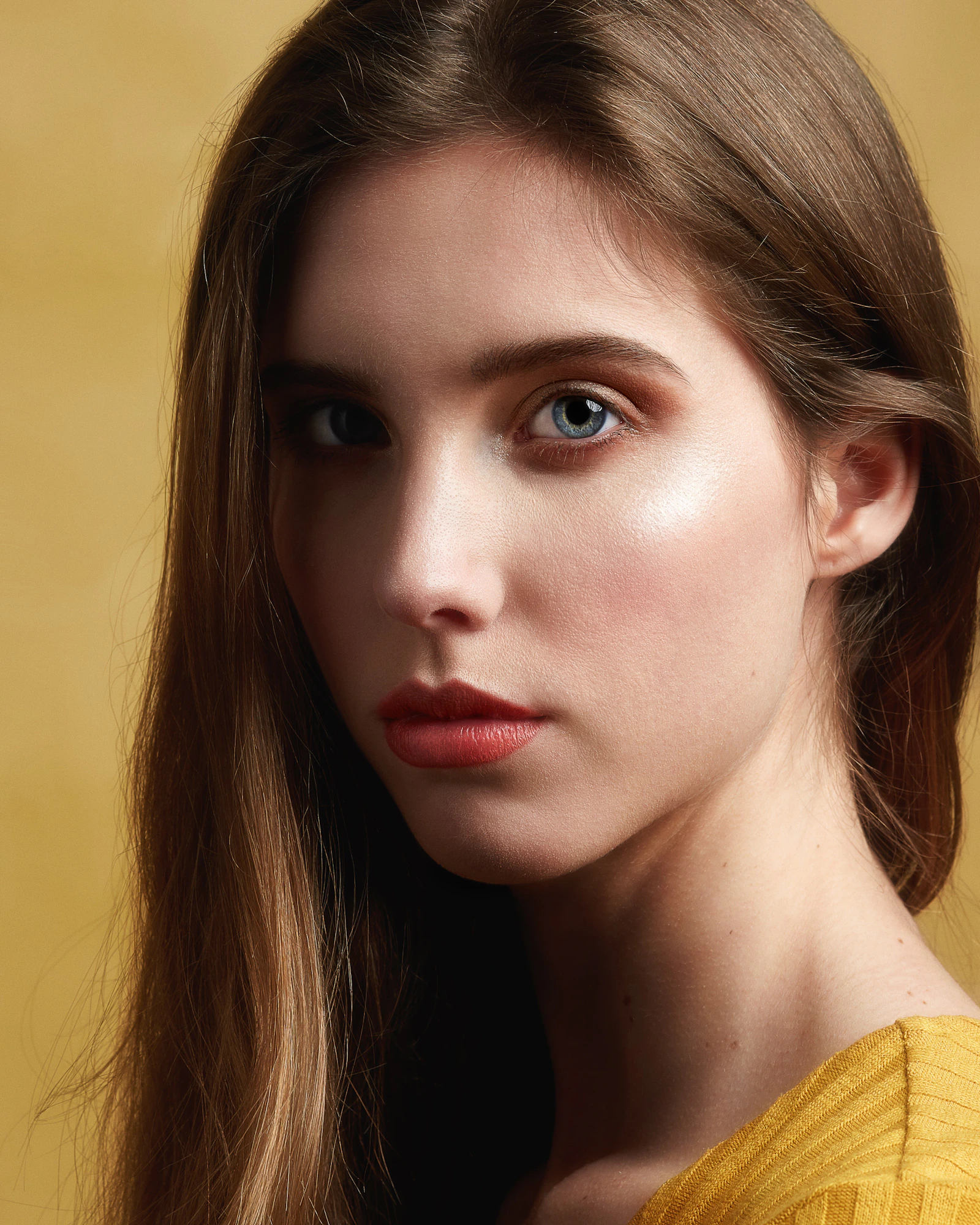 Studio beauty portrait against a dark ground