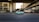 A moving taxi with advertising on its side travels along a multi-lane city road, surrounded by blurred buildings and overpasses, suggesting urban motion and speed.