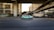 A moving taxi with advertising on its side travels along a multi-lane city road, surrounded by blurred buildings and overpasses, suggesting urban motion and speed.