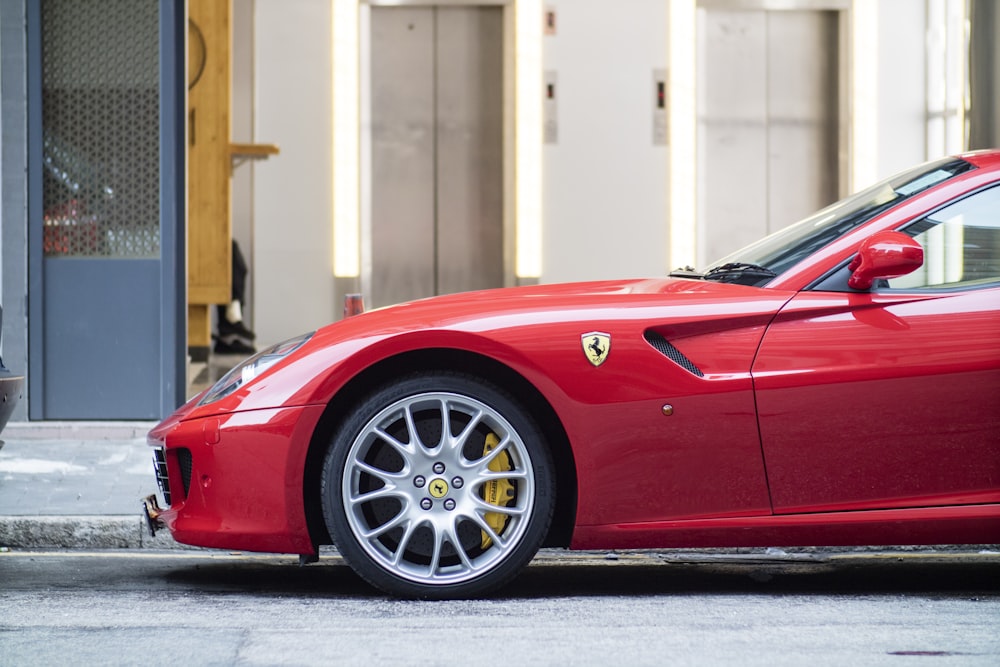 red Ferrari parked near closed blue door