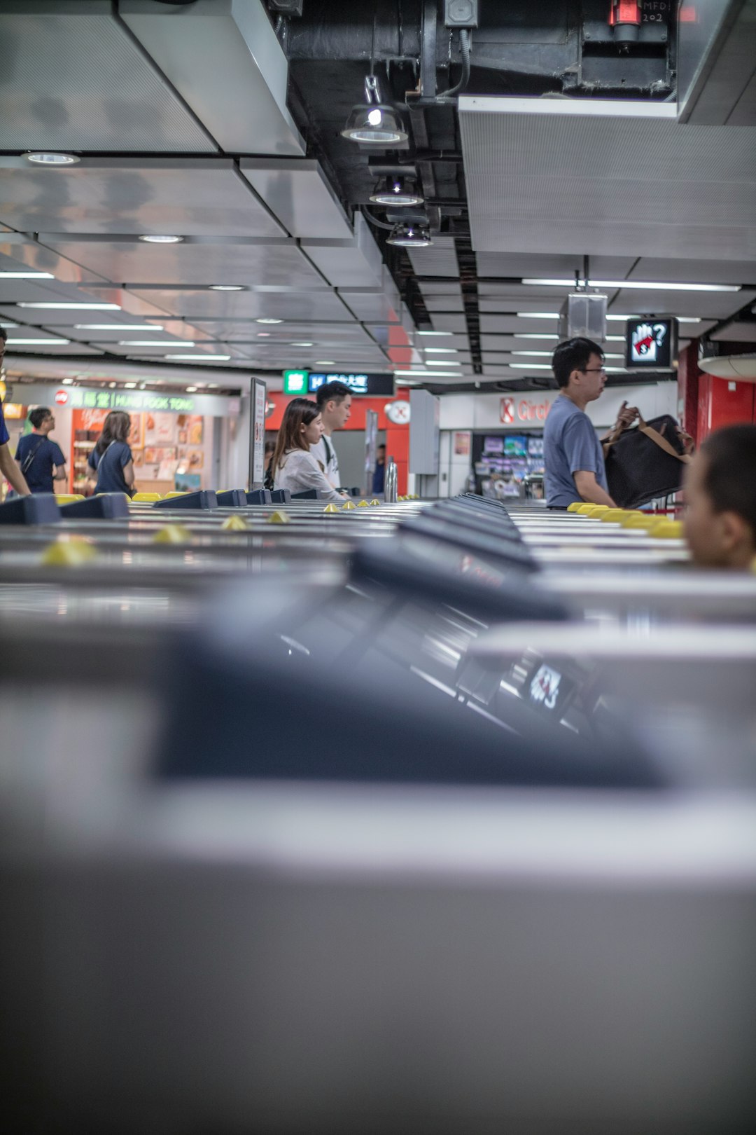 people passing through gates inside airport