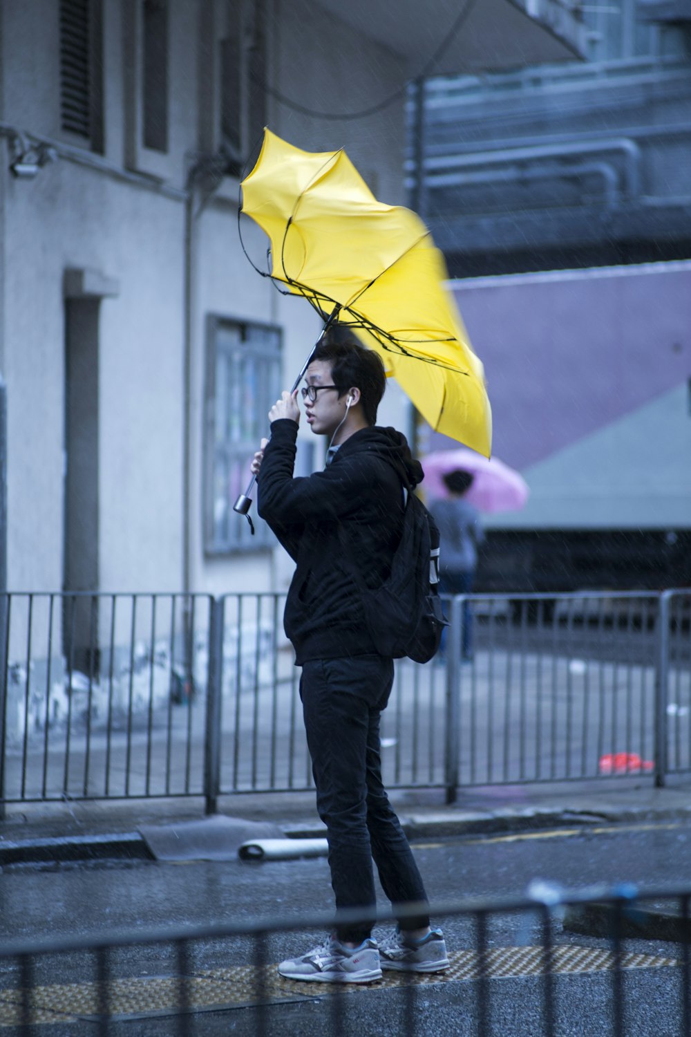 man holding yellow umbrella