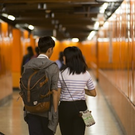 two people walking inside building