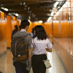 two people walking inside building