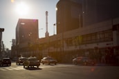 A city street with an Automove car driving during sunset.