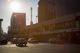 A delivery vehicle speeding through a city street with sunset light.