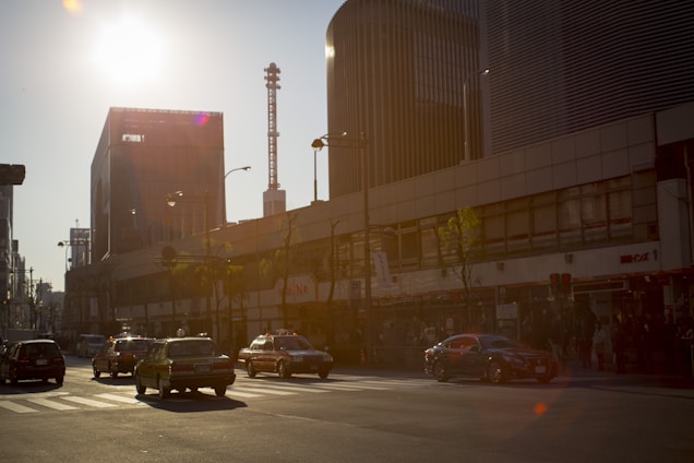 Electric vehicle driving smoothly through a modern city street at sunset.