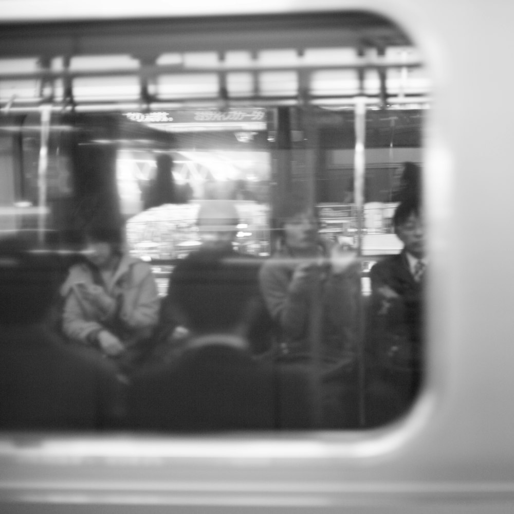 people inside the vehicle grayscale photography