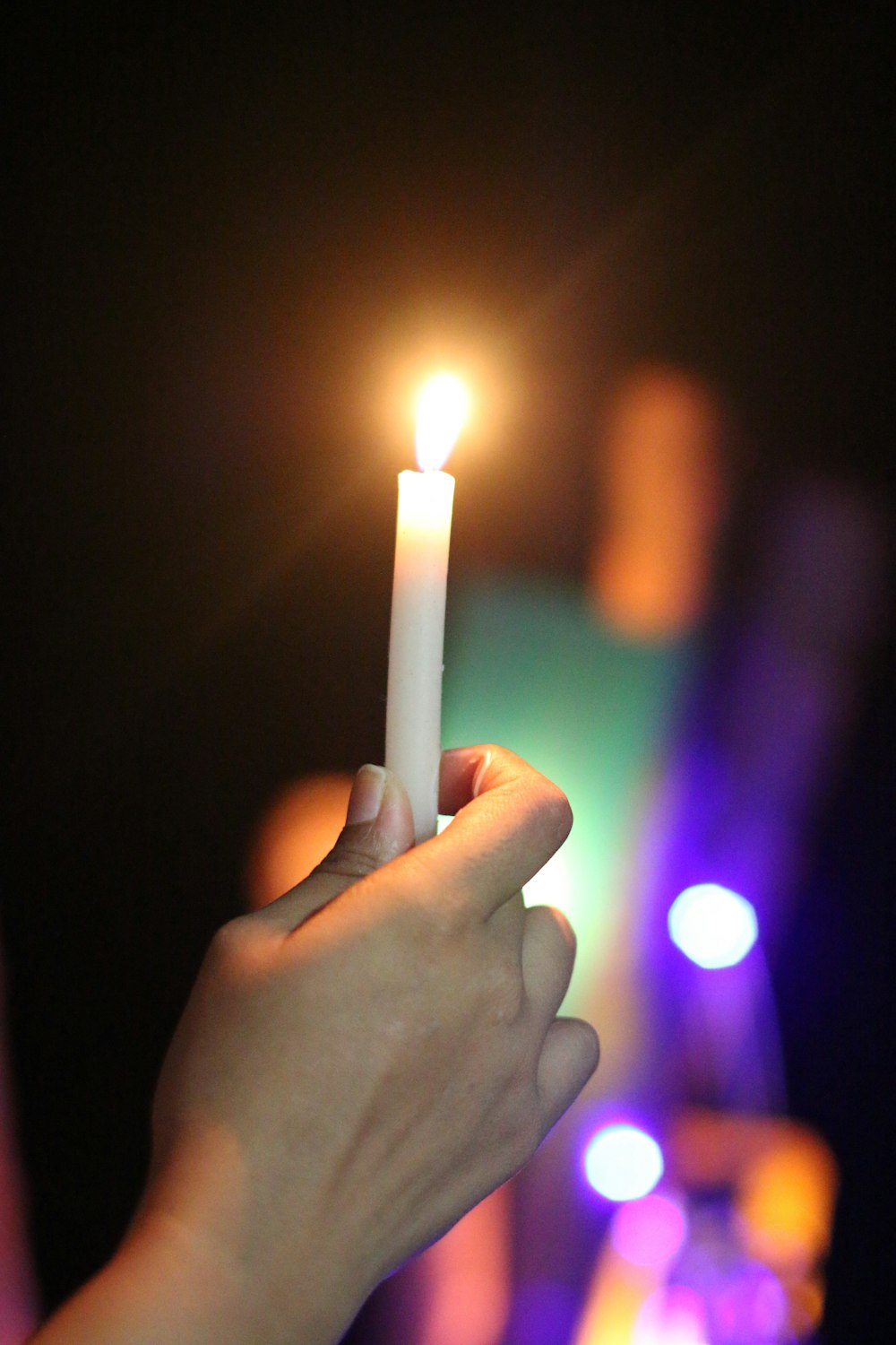 person holding lit candle