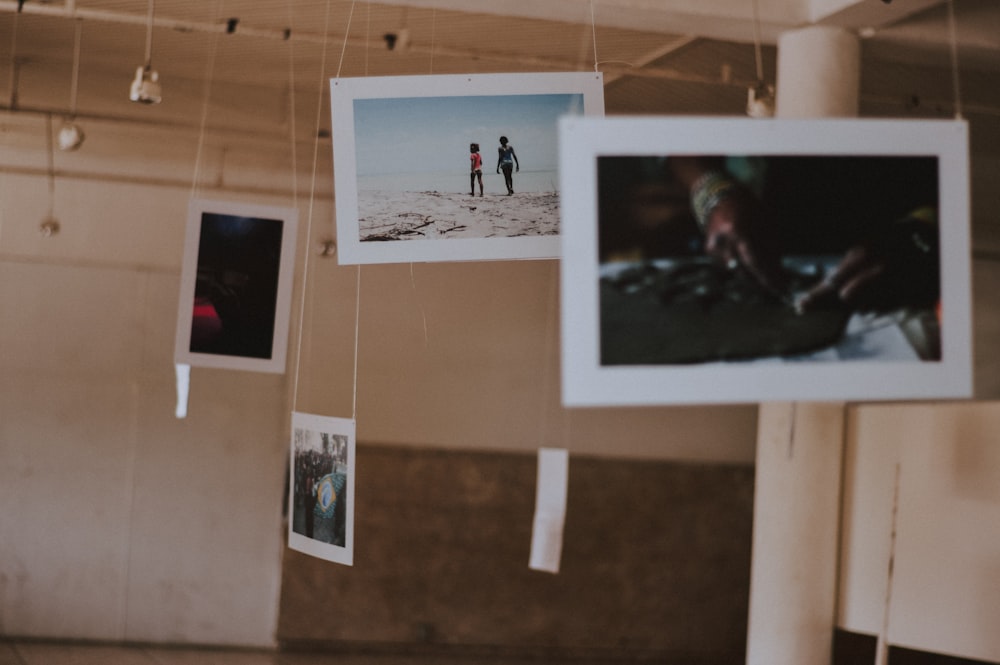 selective focus photography of hanging photos