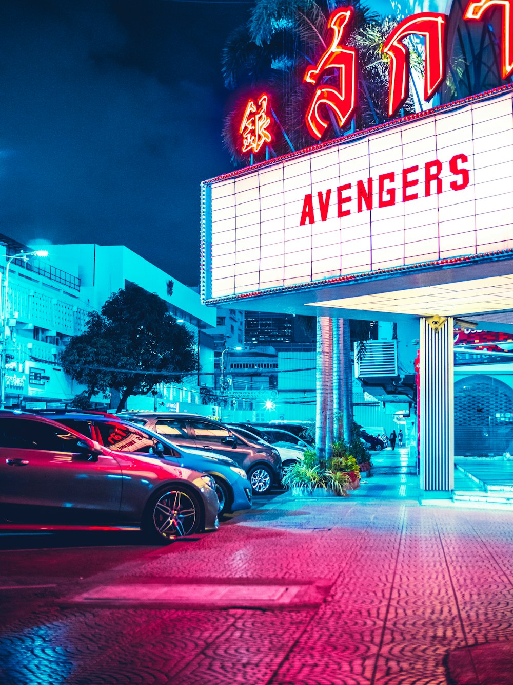 vehicles parked beside Avengers signage