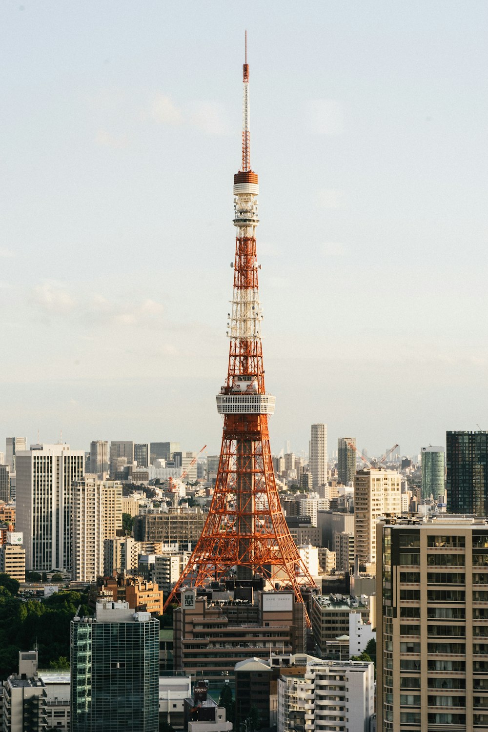 red metal tower in the city during daytime