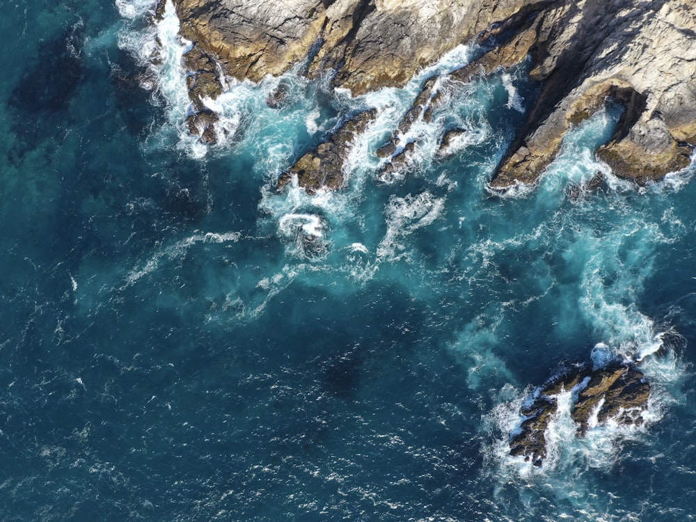 aerial photography of rocks and ocean