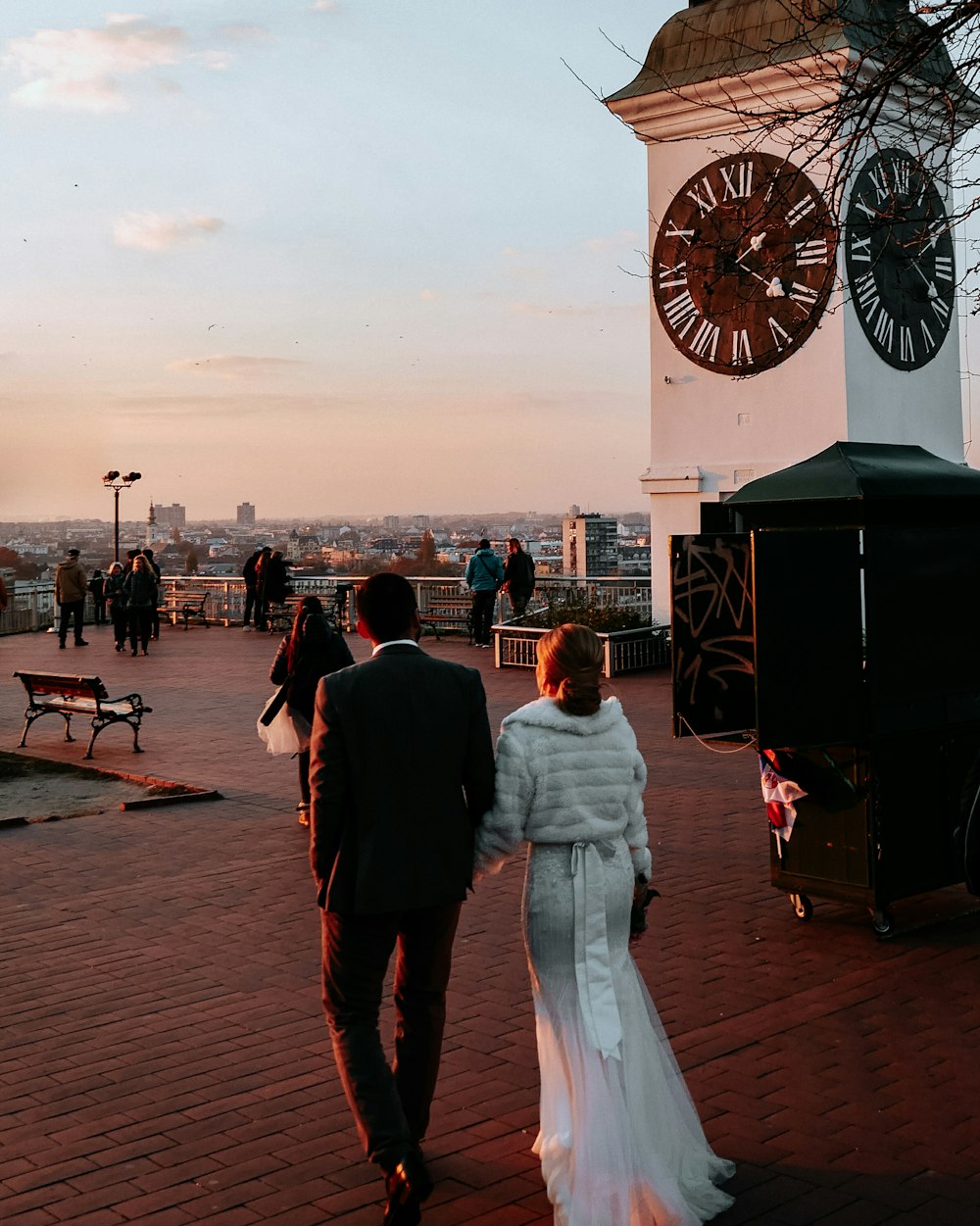 man and woman walking near stall