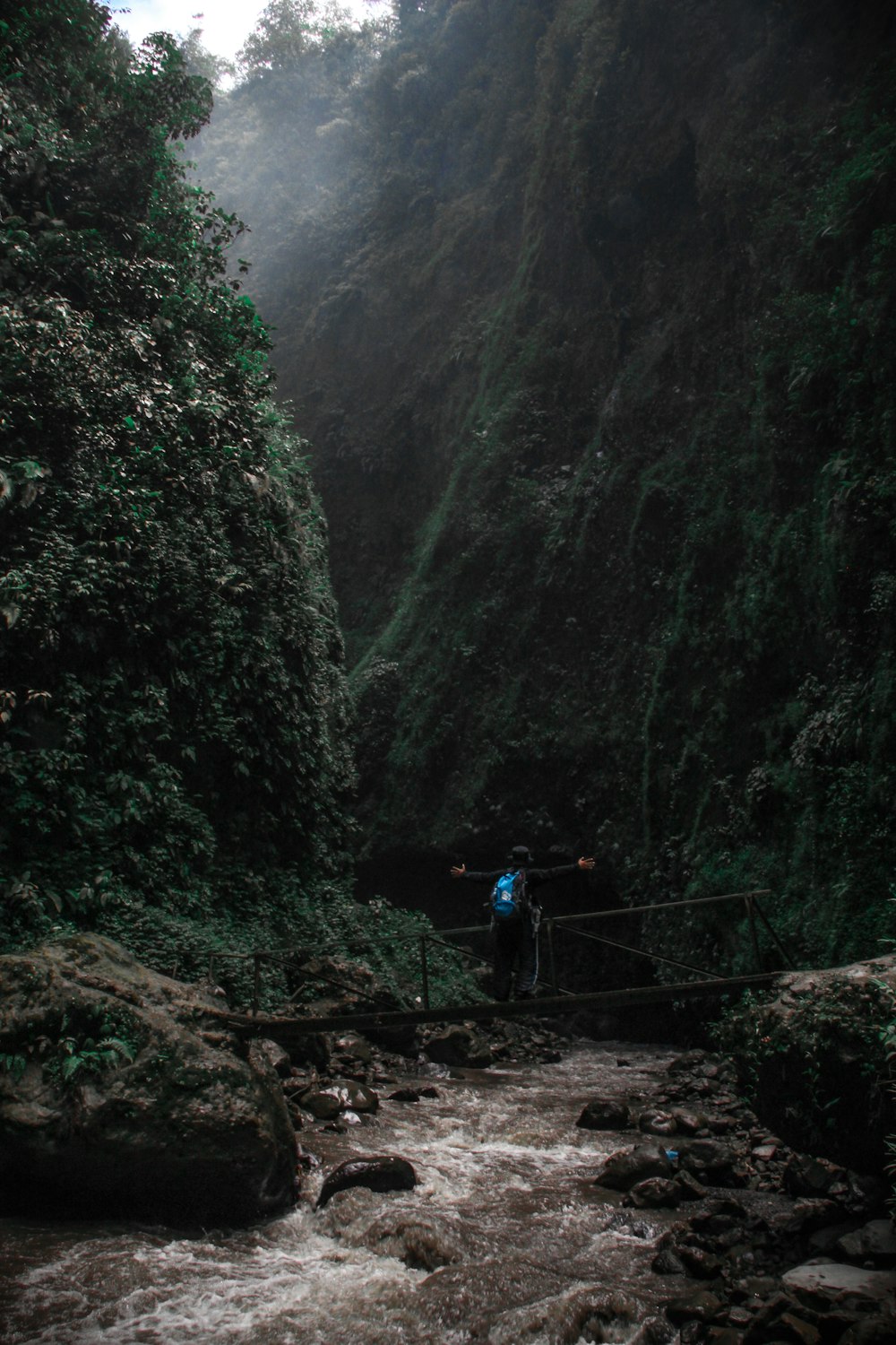 man standing on bridge