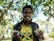 A happy customer holding a jar of achar with a big smile.