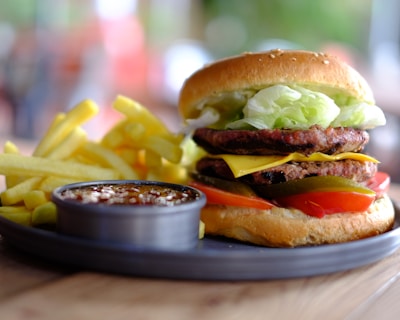 hamburger and fries with dip on tray