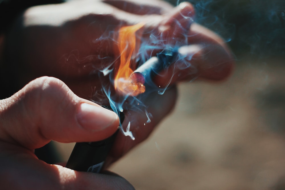 person lighting cigarette