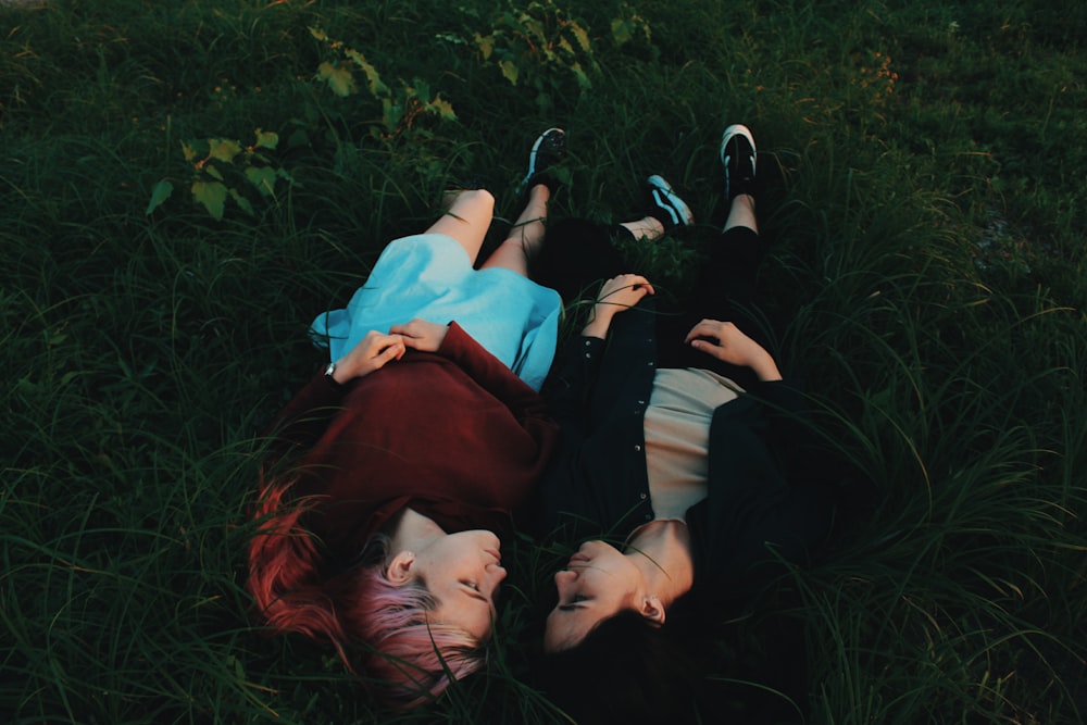 two women lying on grasses