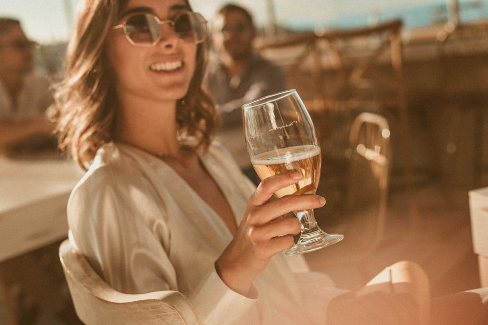 woman carrying wine glass