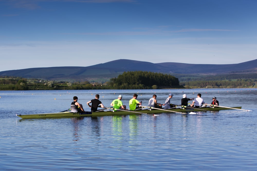 people riding on wooden watercraft