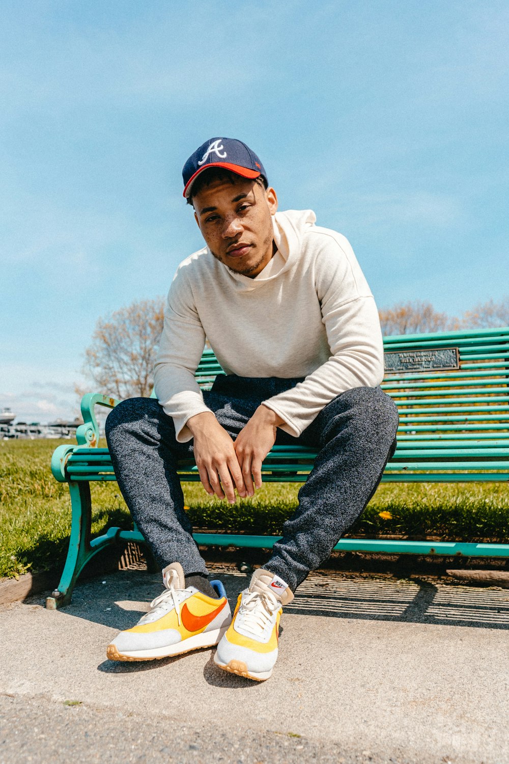 man wearing grey pants sitting on bench