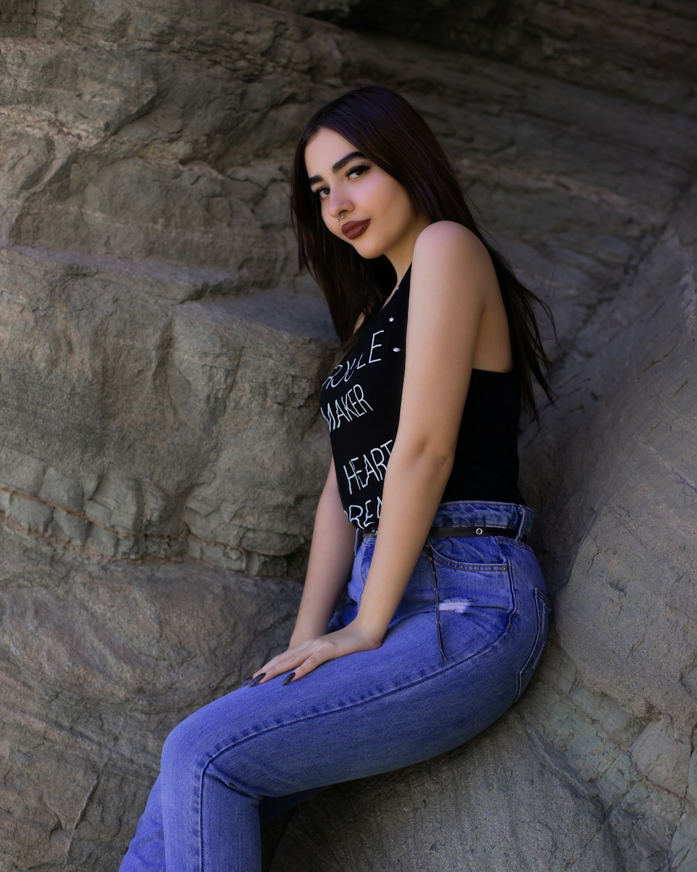 woman in black sleeveless top and blue jeans