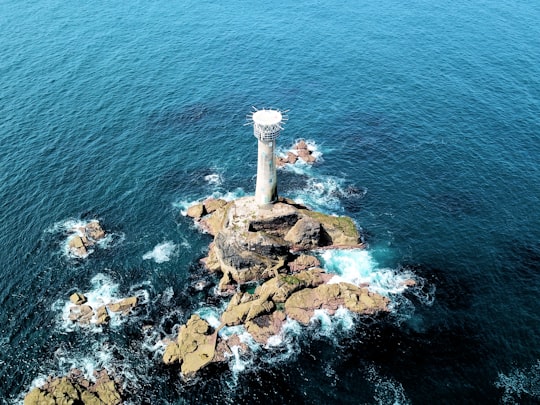 aerial view of lighthouse surrounded with water in Sennen United Kingdom