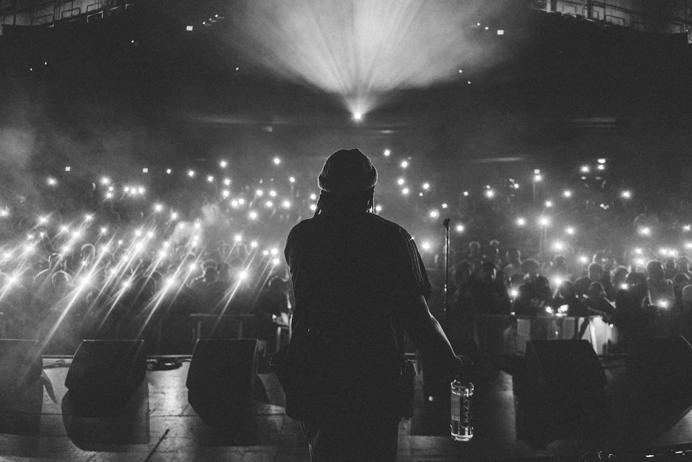 Performer on stage in black and white